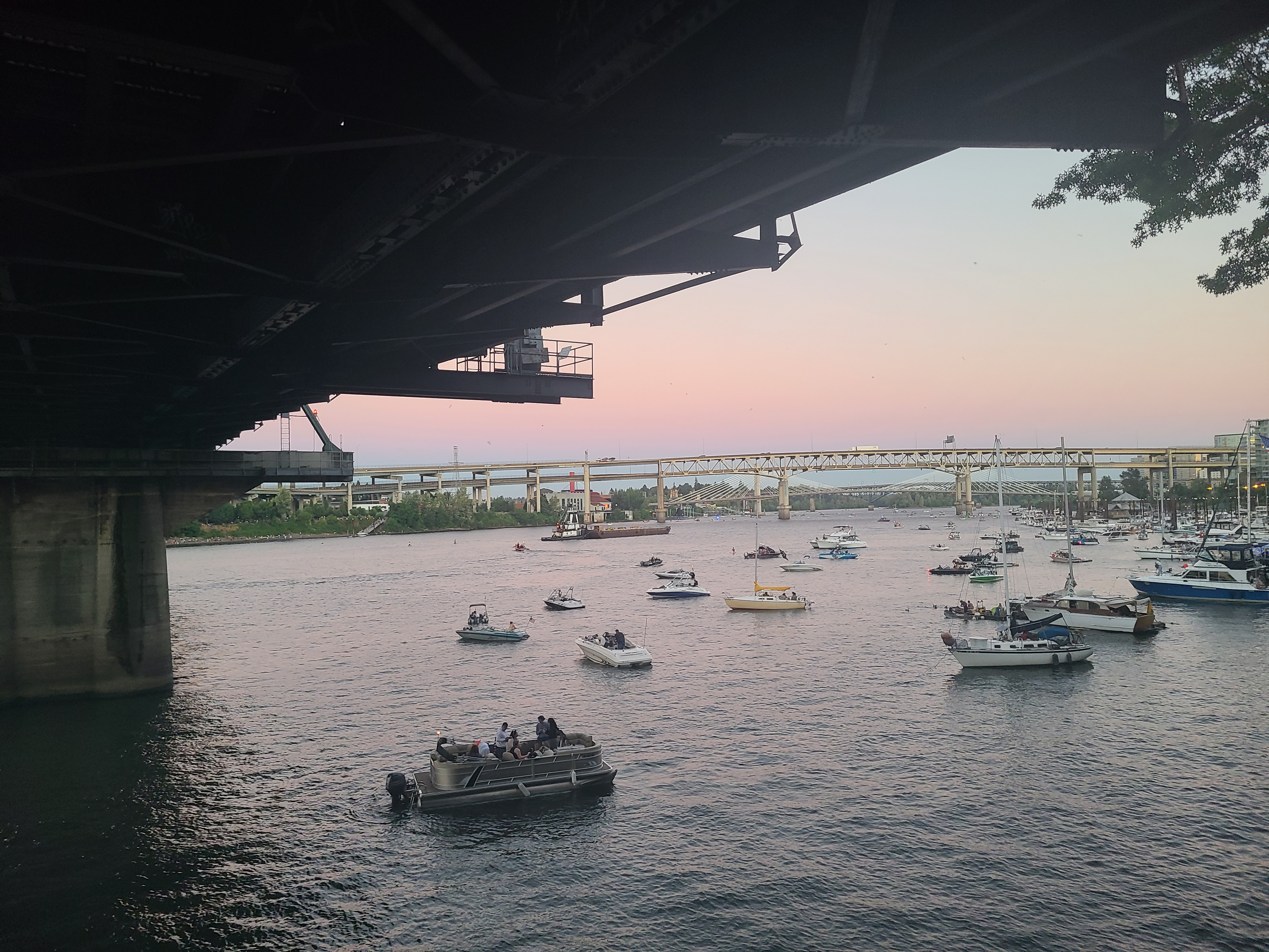 a photo of boats under the bridge by Jodi VanDerVon